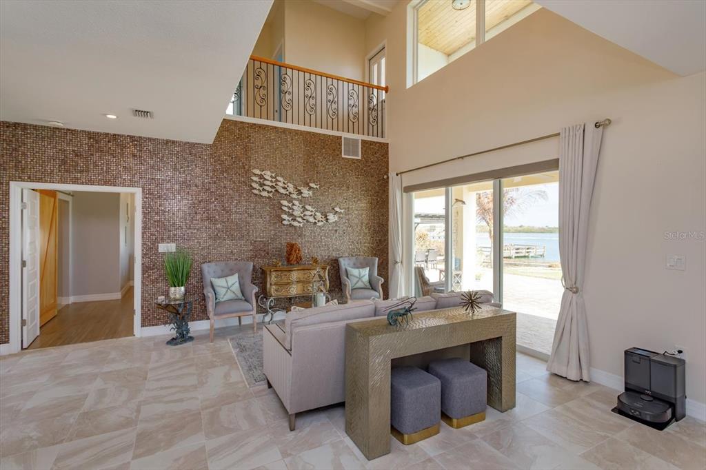 1201 South Riverside Drive Edgewater, FL 32132 - Photo 9 of 47 a living room with furniture a window and a fireplace