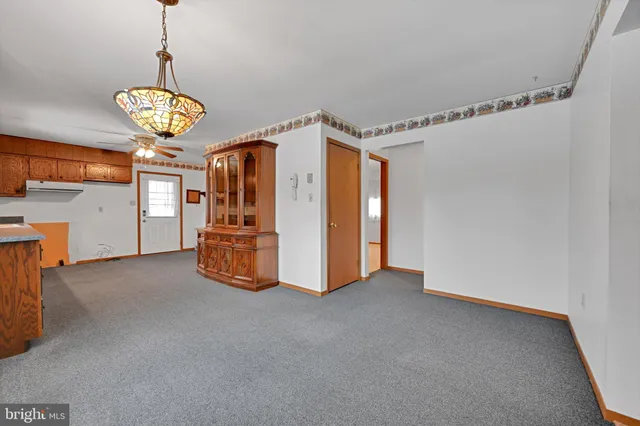 a view of a room with window and chandelier