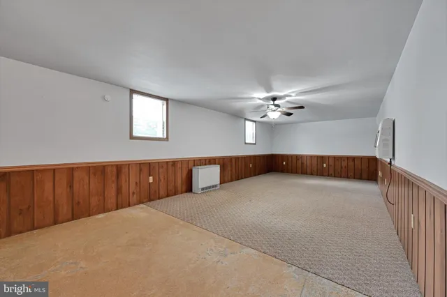 a view of a livingroom with a ceiling fan and window