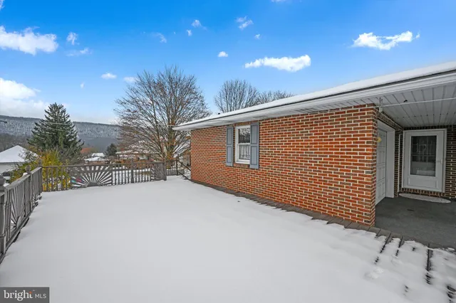 a view of a backyard with a tree