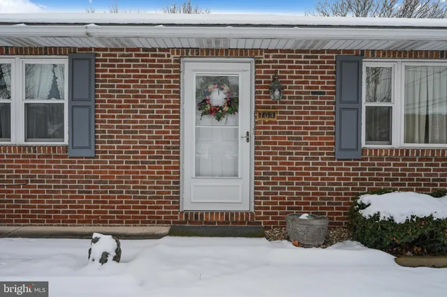 a view of a house with wooden fence