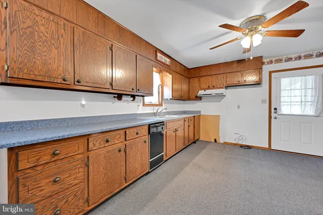 a kitchen with granite countertop cabinets stainless steel appliances and a sink