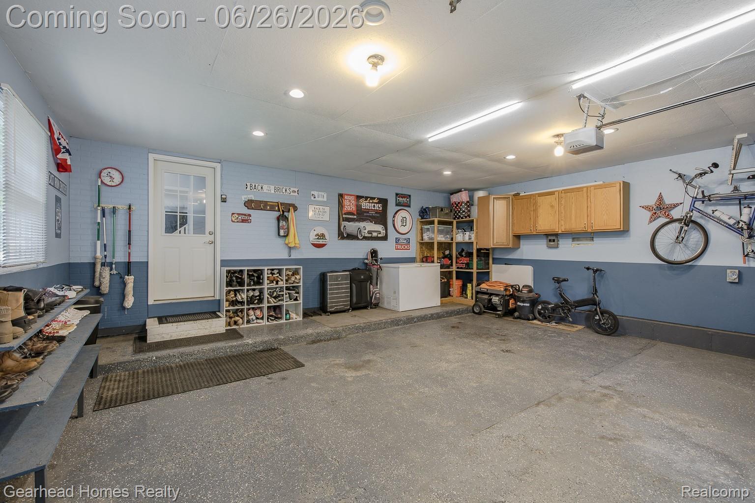 12364 Morrish Road Clio, MI 48420 - Photo 50 of 81 Spacious garage featuring a durable epoxy floor coating, recessed lighting, and ample built-in storage cabinetry