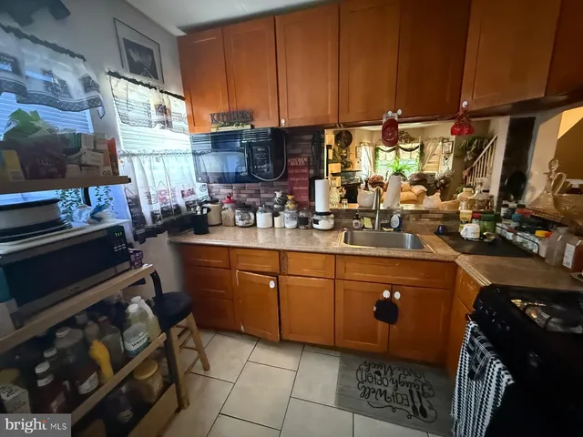 a kitchen with sink cabinets and appliances