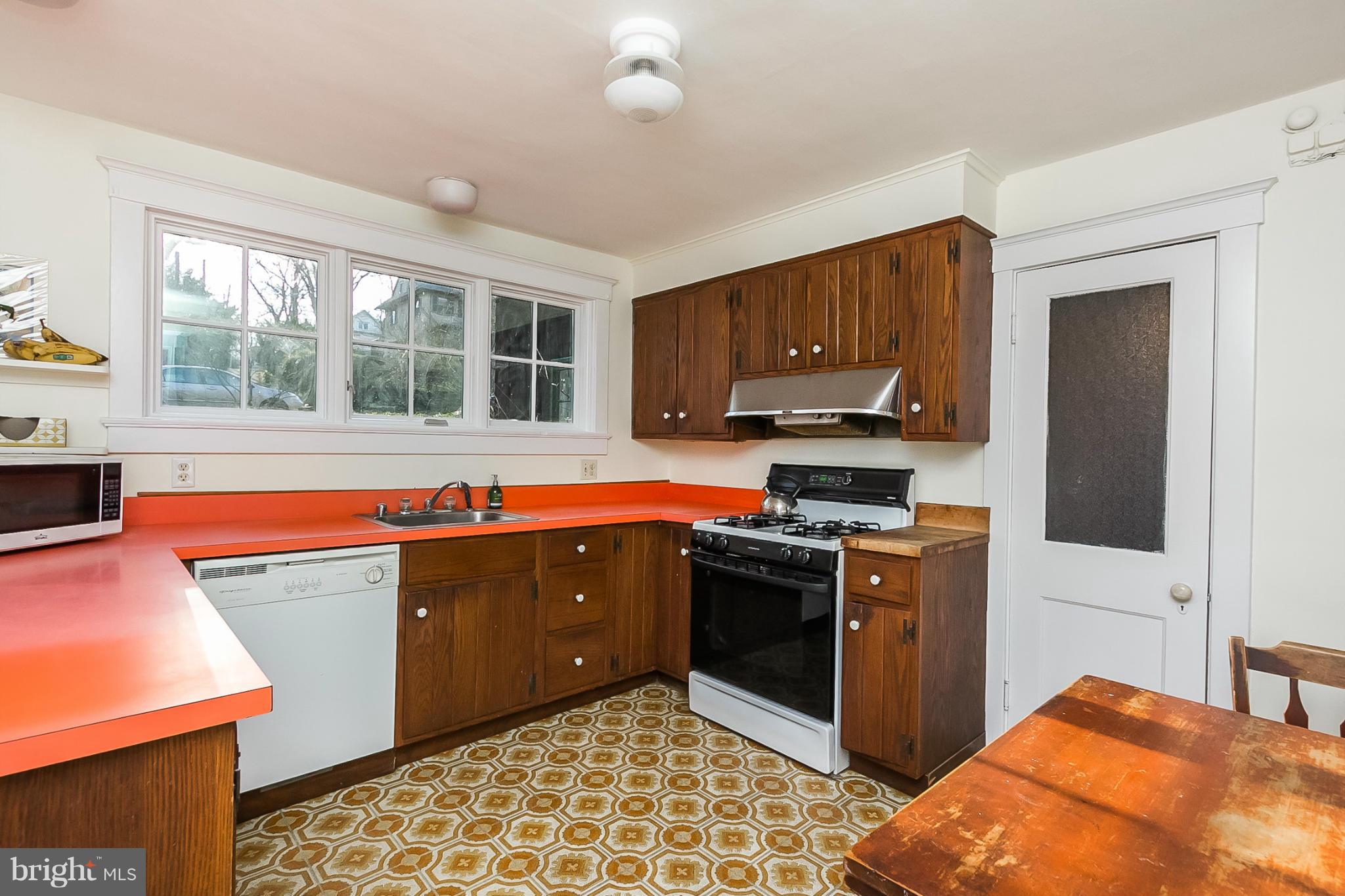 4709 Keswick Road Baltimore, MD 21210 - Photo 16 of 30 a kitchen with stainless steel appliances granite countertop a stove a sink and a microwave