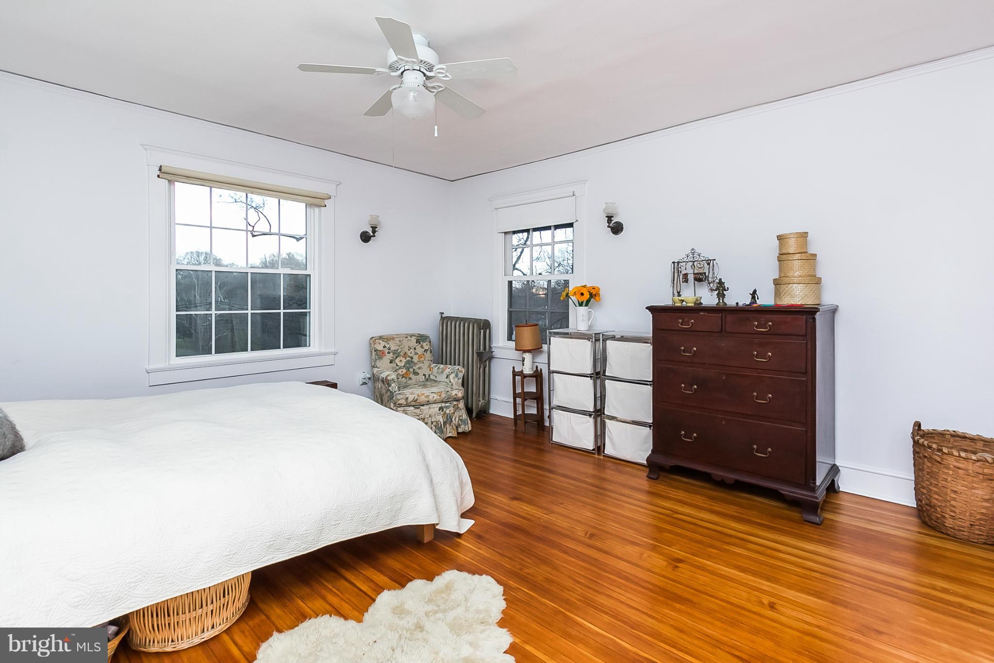 4709 Keswick Road Baltimore, MD 21210 - Photo 19 of 30 a bedroom with a bed and wooden floor