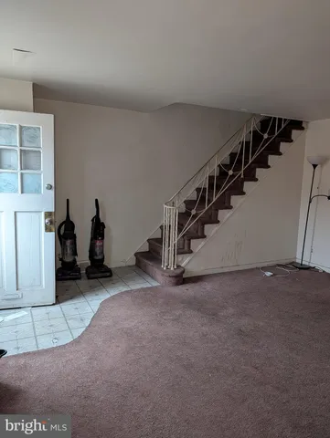 a view of a livingroom with stairs