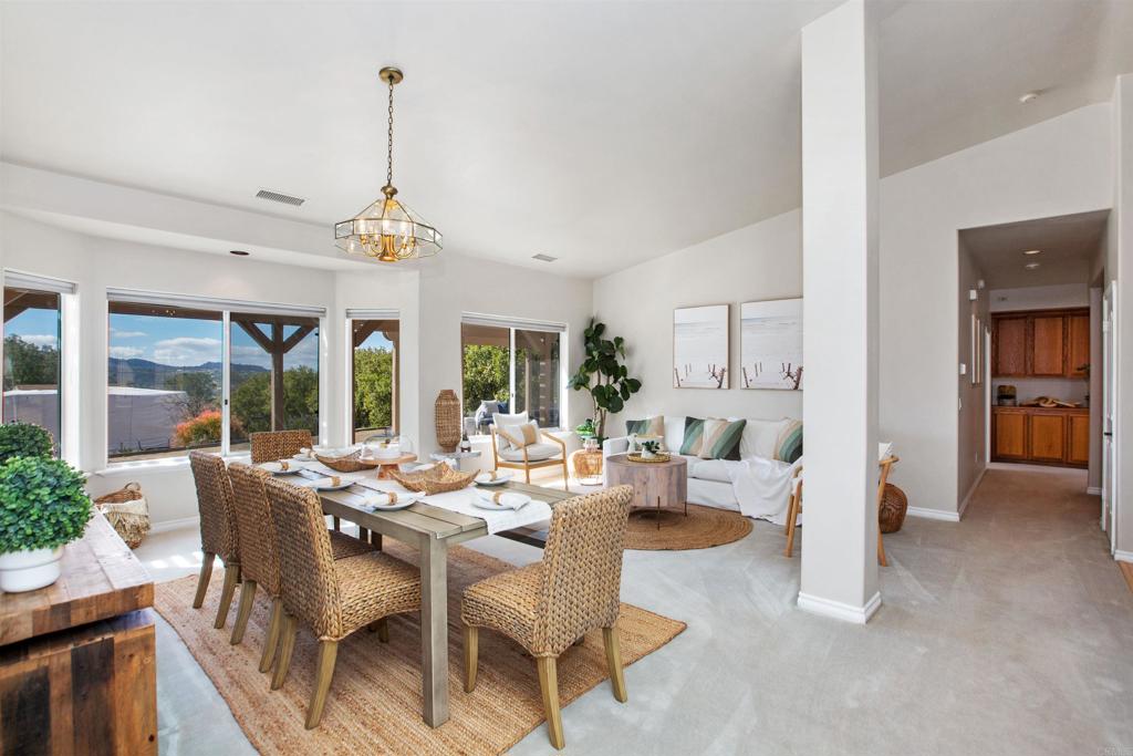 29076 Sunset Road Valley Center, CA 92082 - Photo 14 of 65 a view of a dining room with furniture large windows and wooden floor
