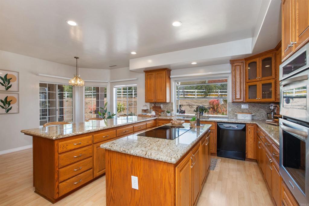 29076 Sunset Road Valley Center, CA 92082 - Photo 22 of 65 a kitchen with a stove and a sink