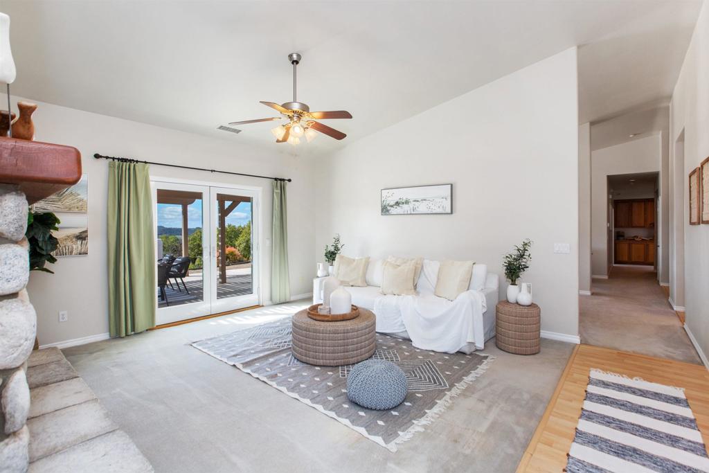 29076 Sunset Road Valley Center, CA 92082 - Photo 24 of 65 a living room with furniture a window and a chandelier