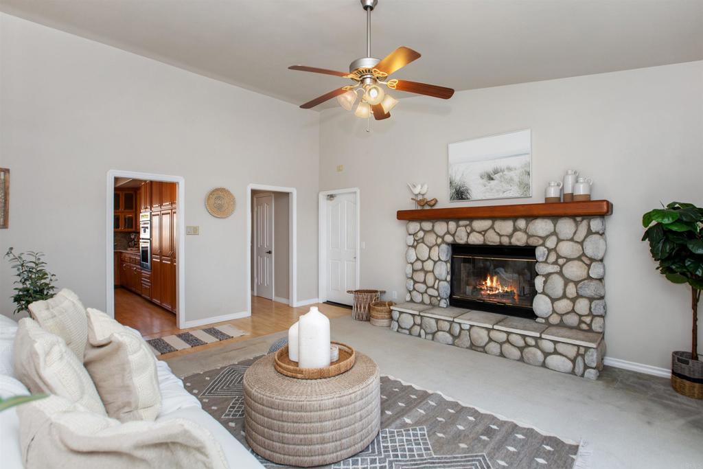29076 Sunset Road Valley Center, CA 92082 - Photo 26 of 65 a living room with furniture and a fireplace
