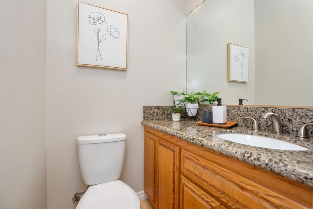 29076 Sunset Road Valley Center, CA 92082 - Photo 28 of 65 a bathroom with a granite countertop toilet sink and mirror