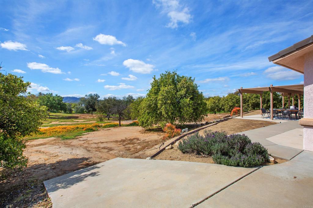 29076 Sunset Road Valley Center, CA 92082 - Photo 45 of 65 a view of a swimming pool with an outdoor space and seating area