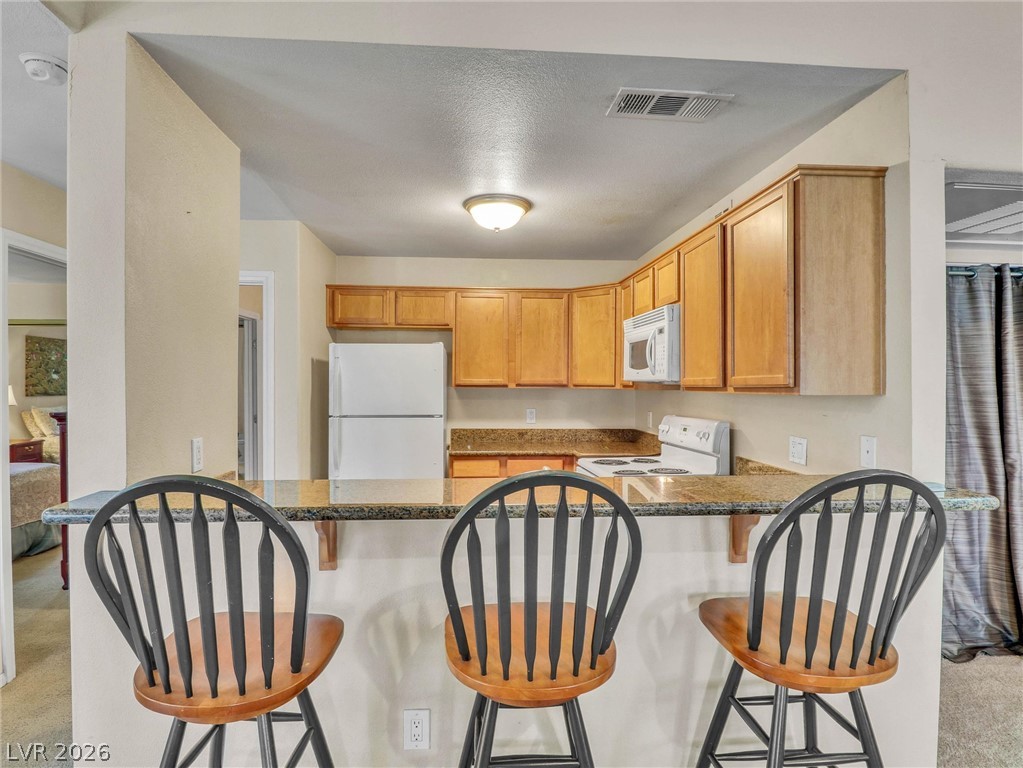 3145 East Flamingo Road, Unit 2129 Las Vegas, NV 89121 - Photo 7 of 43 A functional kitchen provides ample counter space for meal preparation and casual dining.
