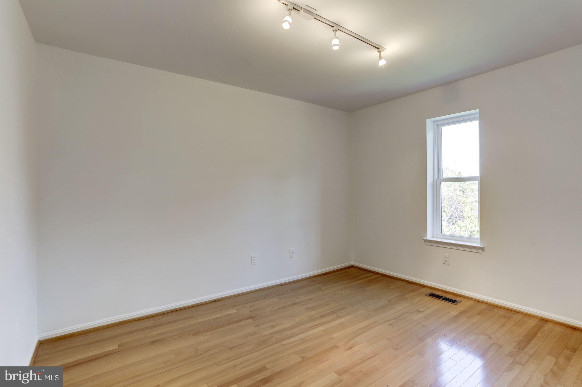 1325 13th Street Northwest, Unit 24 Washington, DC 20005 - Photo 15 of 30 an empty room with wooden floor and windows