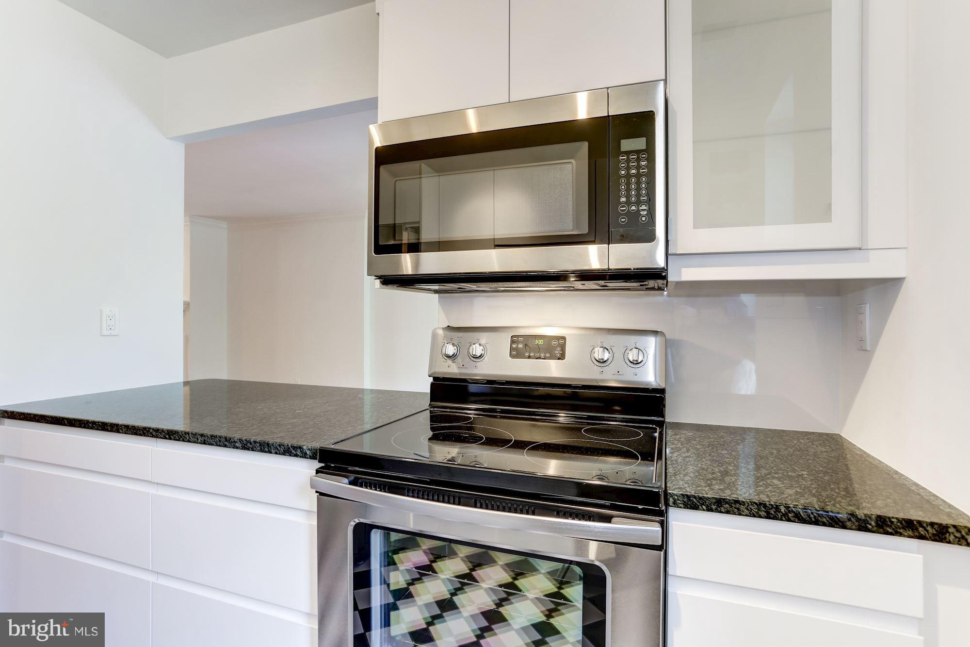 1325 13th Street Northwest, Unit 24 Washington, DC 20005 - Photo 8 of 30 a kitchen with microwave cabinets and a stove top oven
