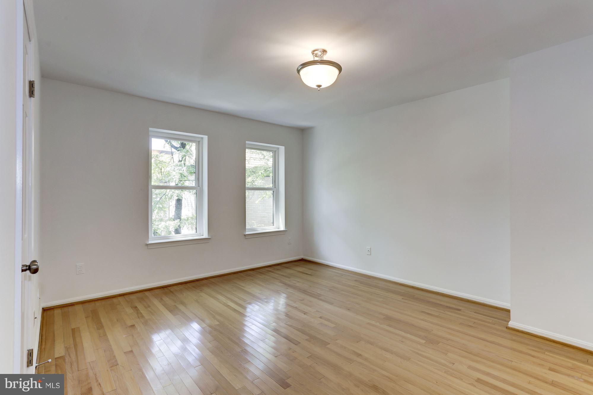 1325 13th Street Northwest, Unit 24 Washington, DC 20005 - Photo 10 of 30 wooden floor in an empty room with a window