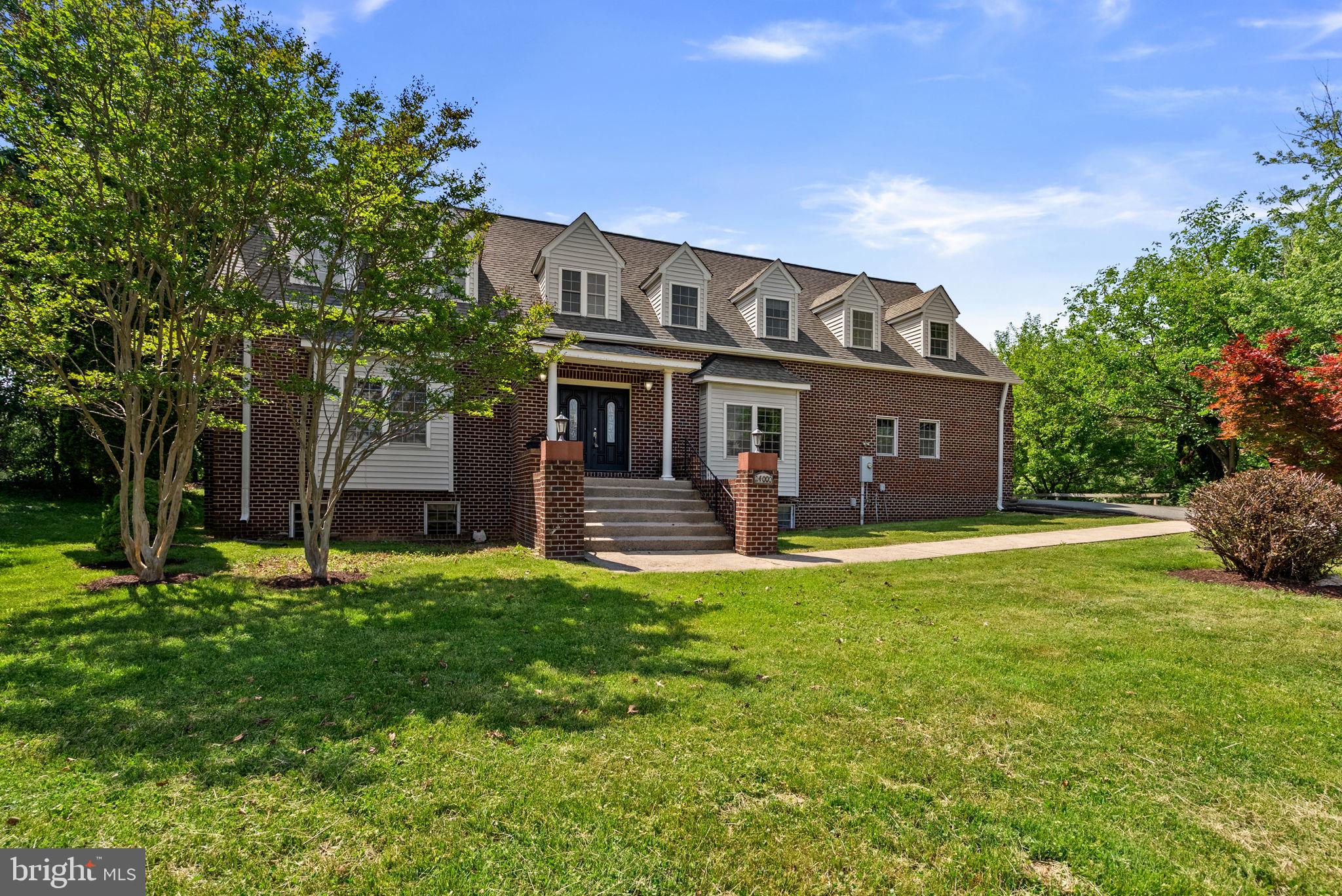 24000 Clarksburg Road Clarksburg, MD 20871 - Photo 2 of 60 a front view of a house with a garden and trees