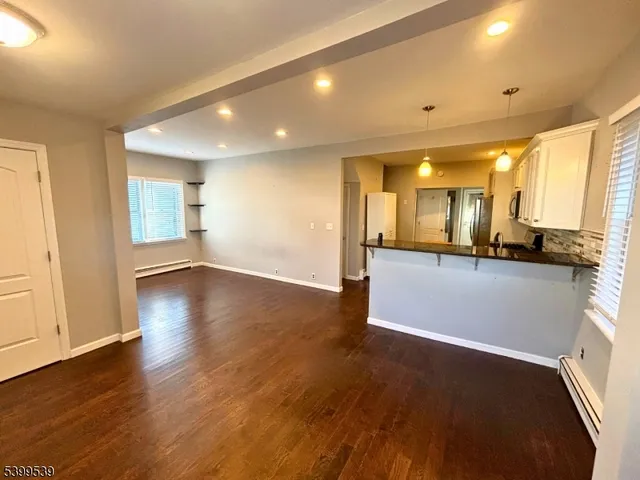 a view of a kitchen with a sink and a stove top oven