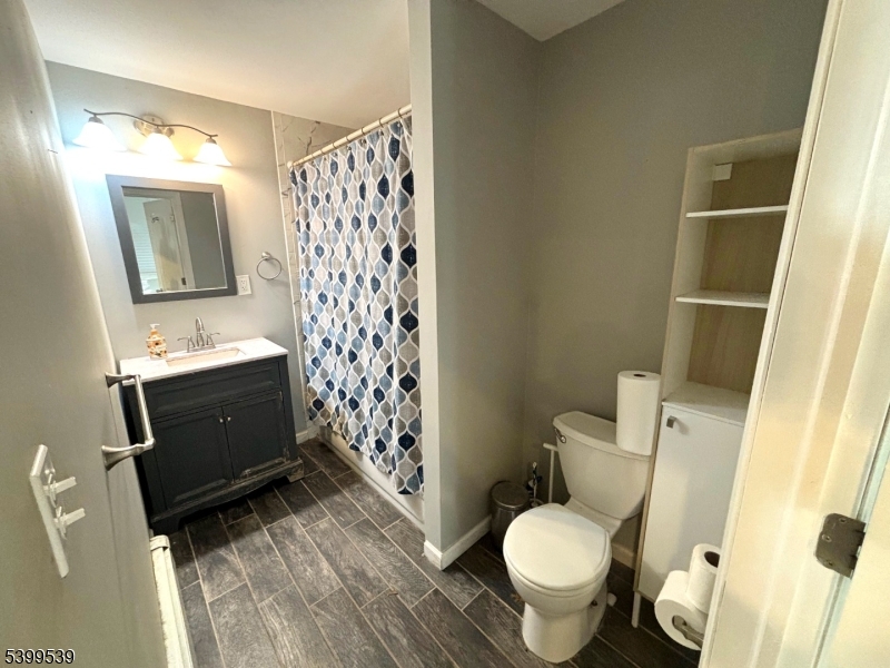 11 Garfield Road Parsippany, NJ 07054 - Photo 8 of 8 a bathroom with a toilet sink and shower