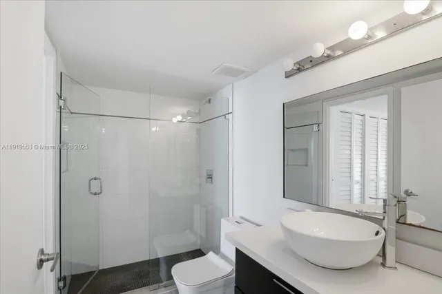 a bathroom with a toilet a sink and shower