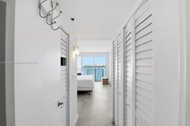 a view of a bedroom with a bed and window