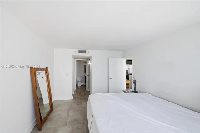 a bedroom with a bed and a mirror