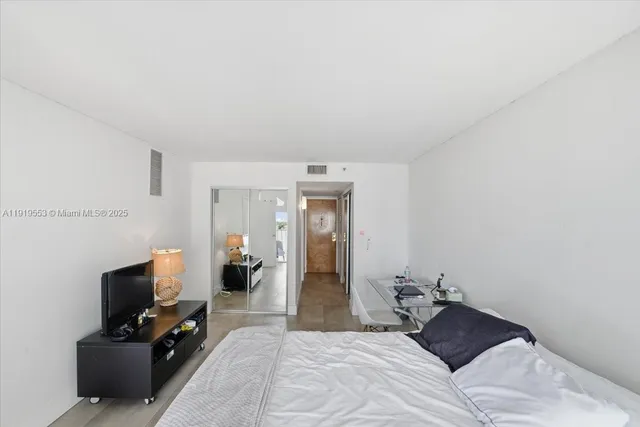 a bedroom with a bed and a television