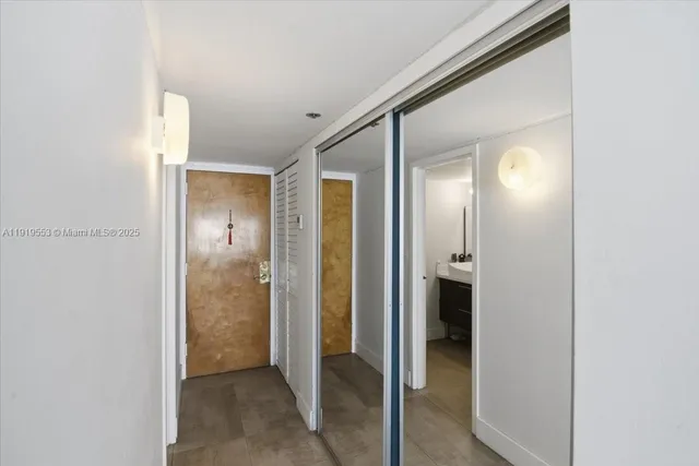 a view of a hallway with wooden shelves