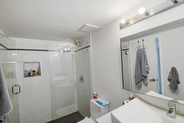 a bathroom with a sink toilet and shower