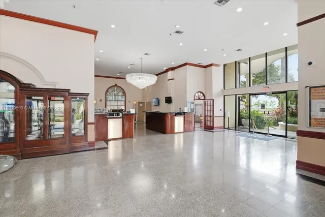 a view of a building with a large window and potted plants