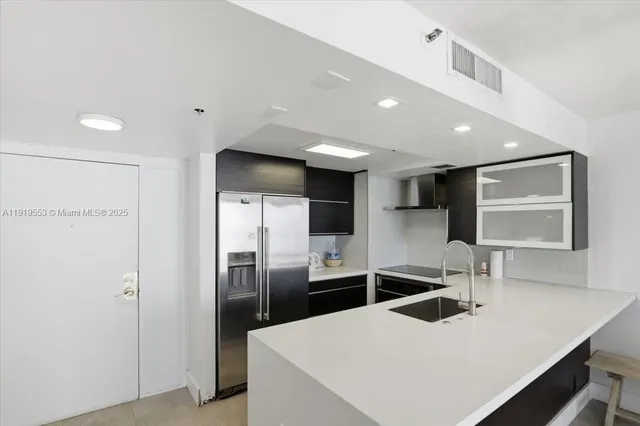 a kitchen with stainless steel appliances a refrigerator and a sink