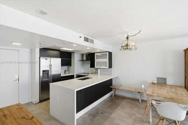 a kitchen with a sink appliances and cabinets