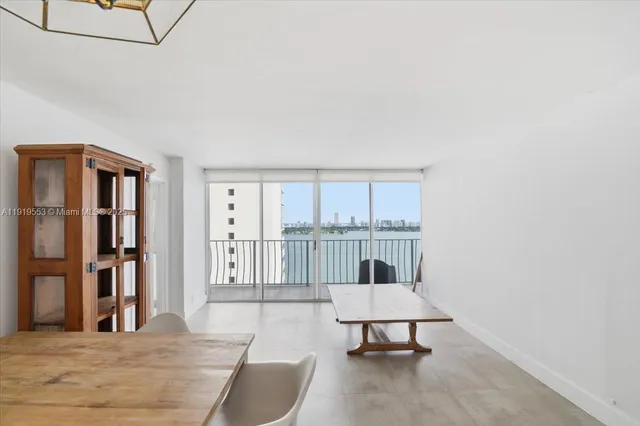 a living room with furniture a window and a table