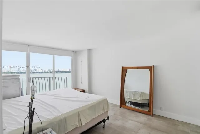 a bedroom with a bed and a mirror