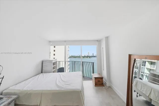 a bedroom with a bed and a large window