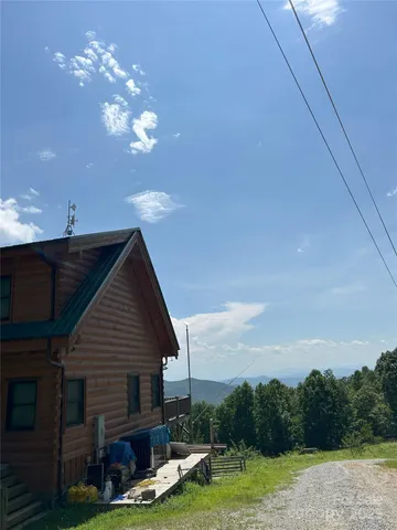 a view of a house with a yard and entertaining space