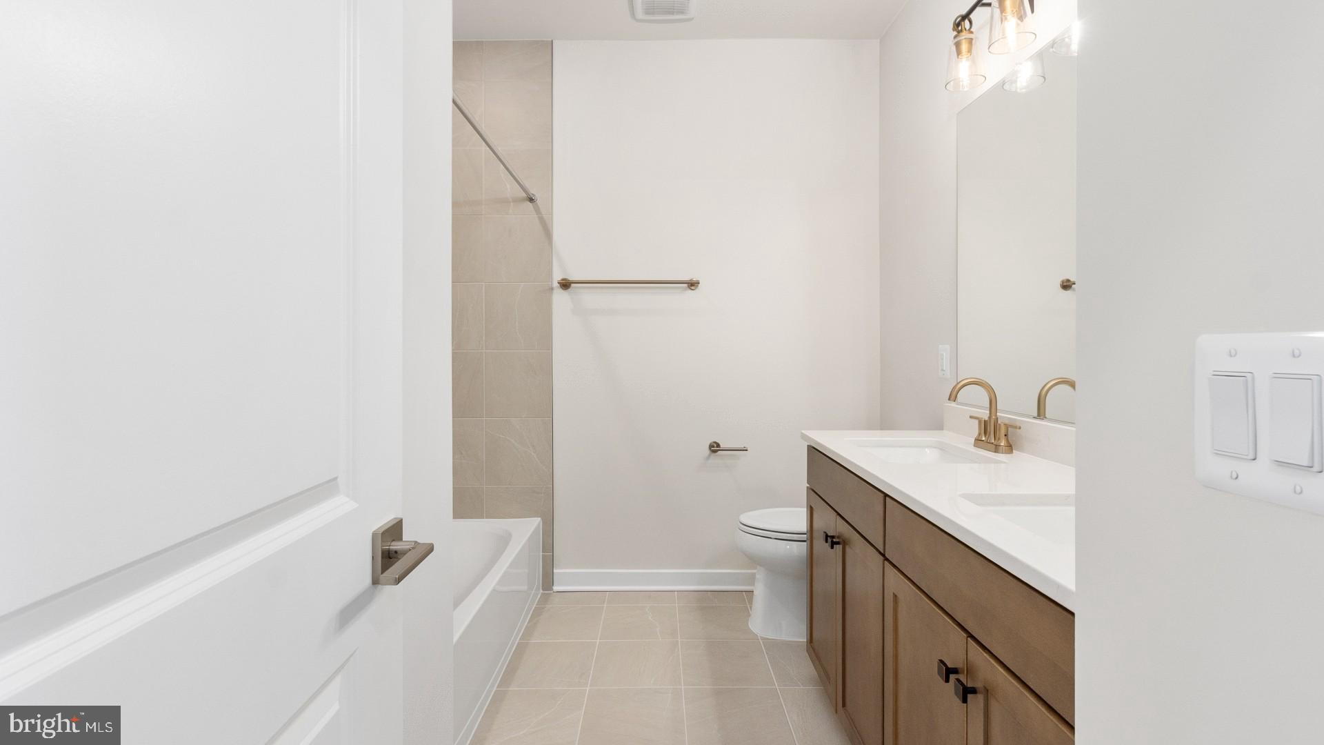 44588 Strabane Terrace Ashburn, VA 20147 - Photo 18 of 26 a bathroom with a sink a toilet and shower