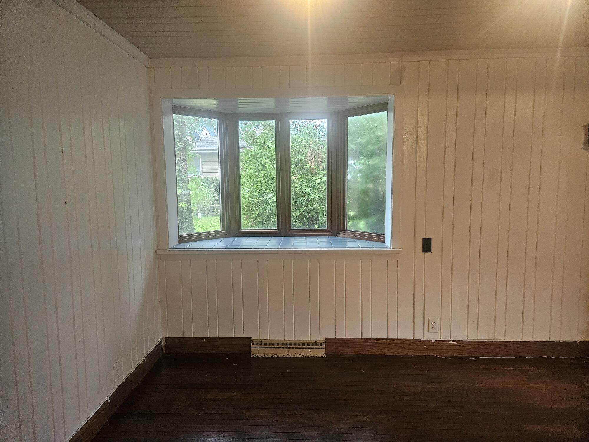 683 Waverly Road La Porte, IN 46350 - Photo 22 of 54 a view of an empty room with wooden floor and a window