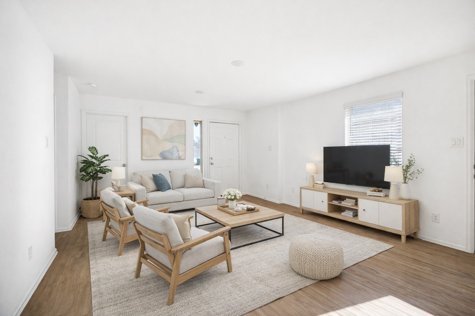 a living room with furniture a flat screen tv and a window