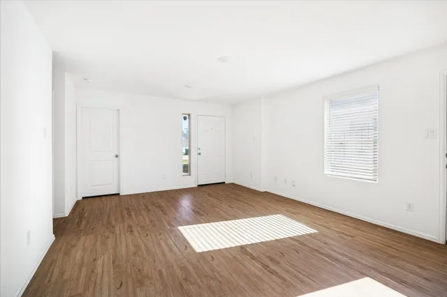 an empty room with wooden floor
