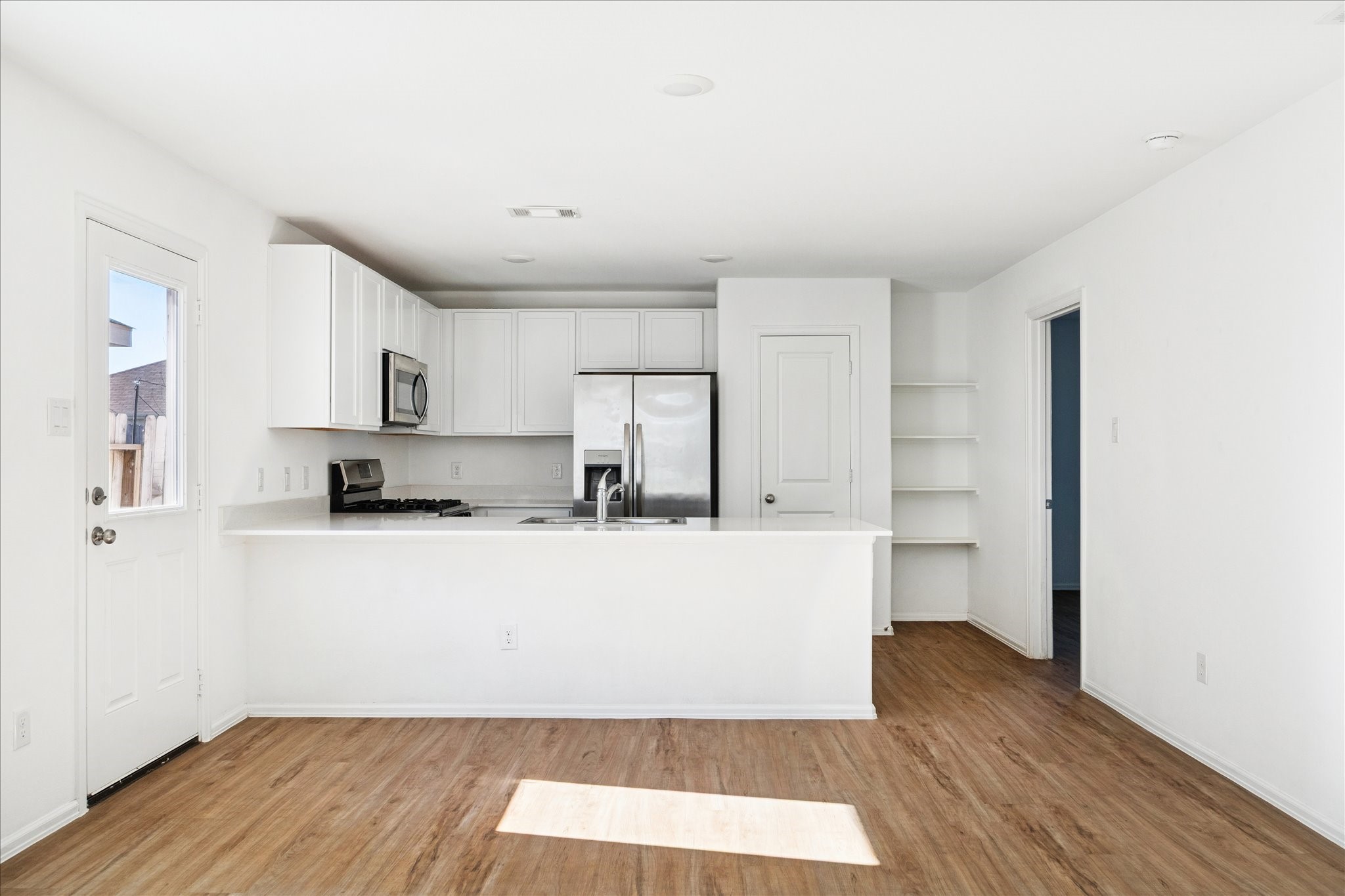 19642 Rupetti Drive New Caney, TX 77357 - Photo 7 of 14 a living room with stainless steel appliances wooden floors and view living room