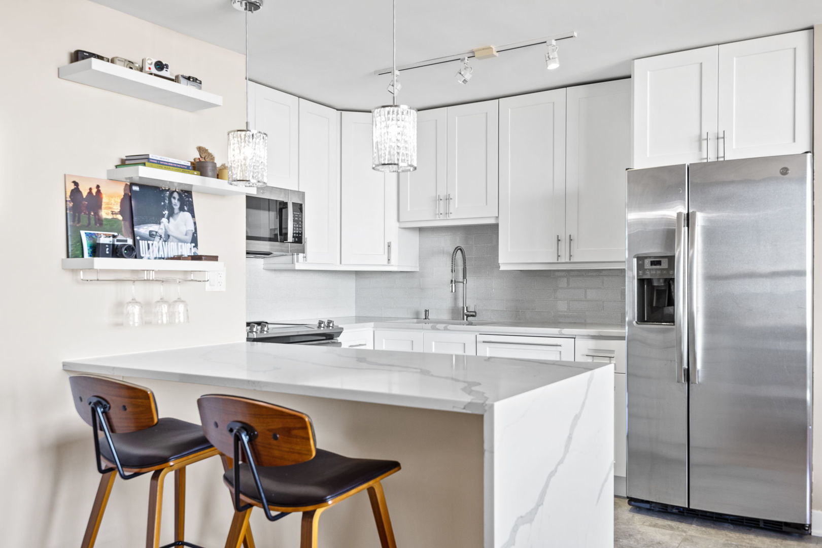655 West Irving Park Road, Unit 3708 Chicago, IL 60613 - Photo 11 of 55 a kitchen with stainless steel appliances granite countertop a sink and refrigerator