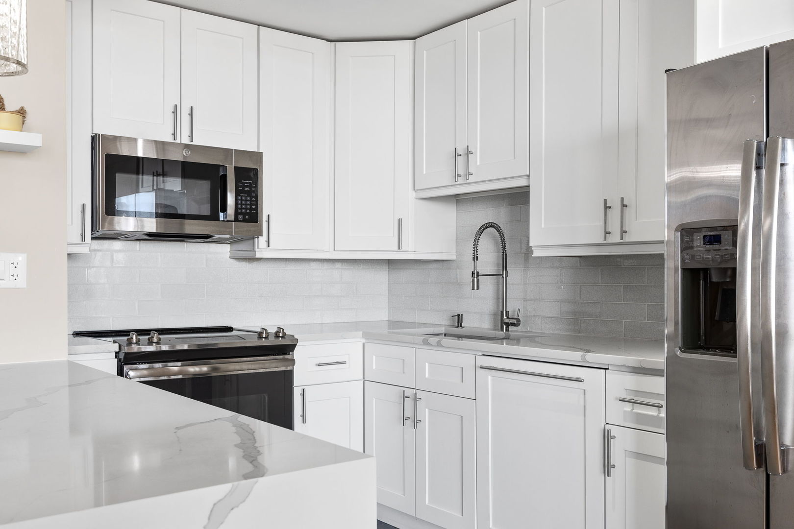 655 West Irving Park Road, Unit 3708 Chicago, IL 60613 - Photo 12 of 55 a kitchen with stainless steel appliances granite countertop white cabinets a stove top oven a sink and dishwasher