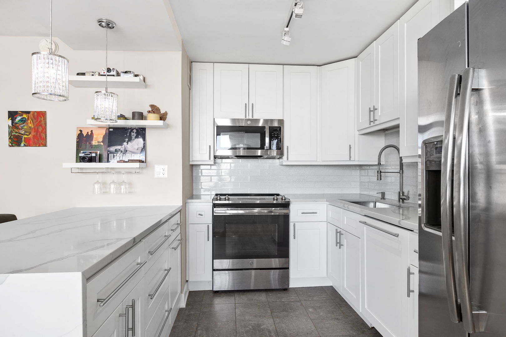 655 West Irving Park Road, Unit 3708 Chicago, IL 60613 - Photo 13 of 55 a kitchen with stainless steel appliances granite countertop a sink stove and refrigerator