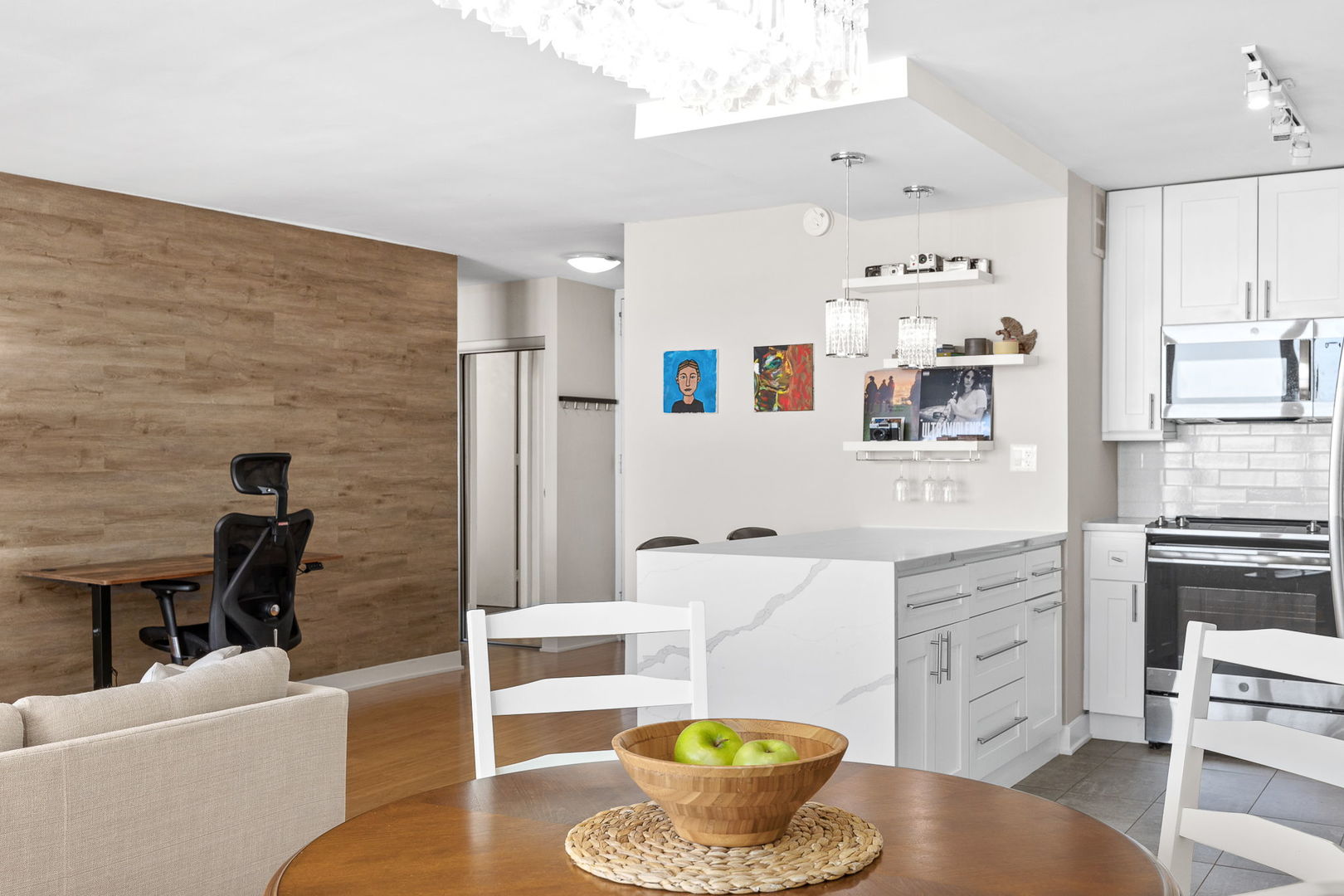 655 West Irving Park Road, Unit 3708 Chicago, IL 60613 - Photo 14 of 55 a living room with stainless steel appliances furniture a rug and a kitchen view