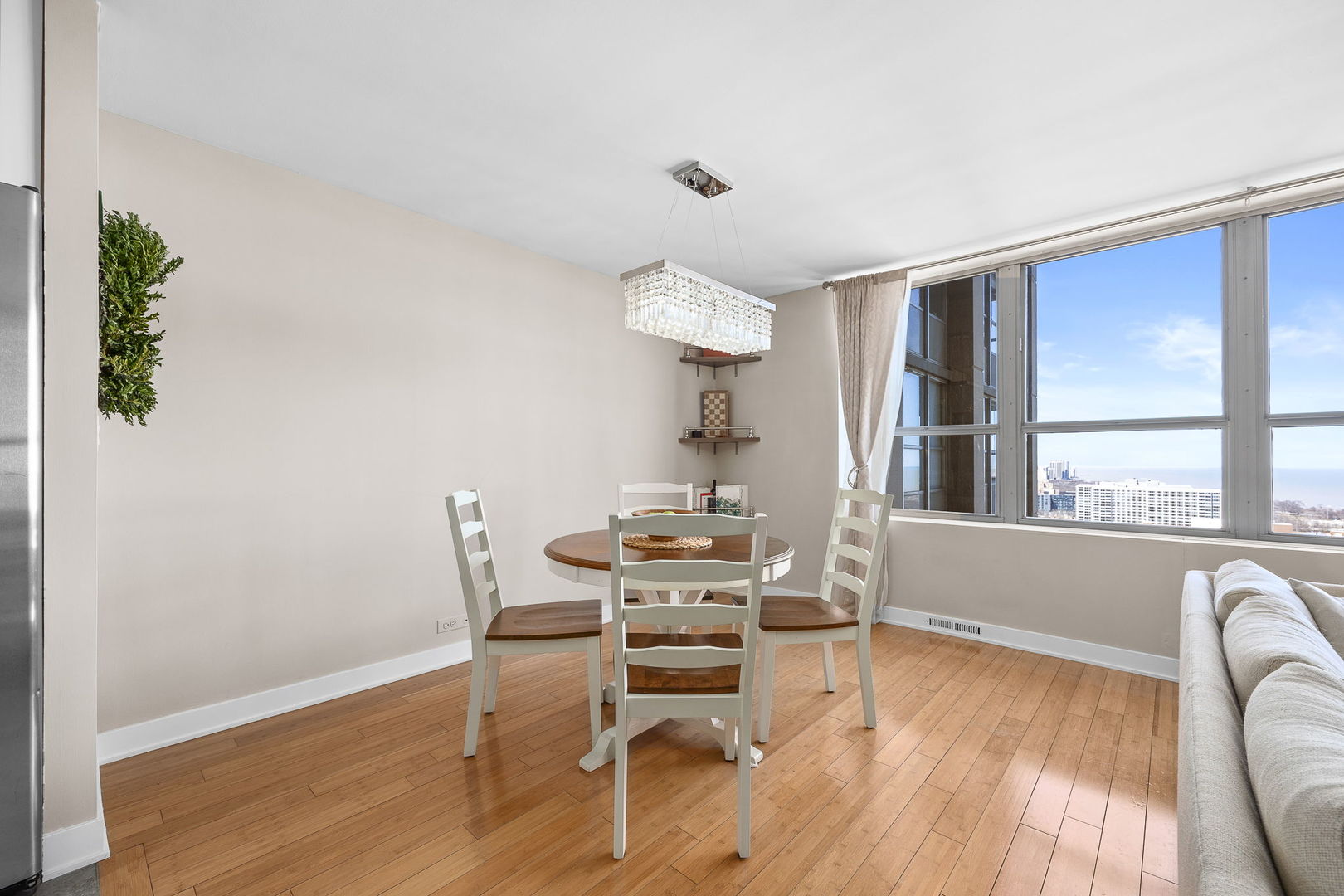 655 West Irving Park Road, Unit 3708 Chicago, IL 60613 - Photo 17 of 55 a dining room with furniture and wooden floor