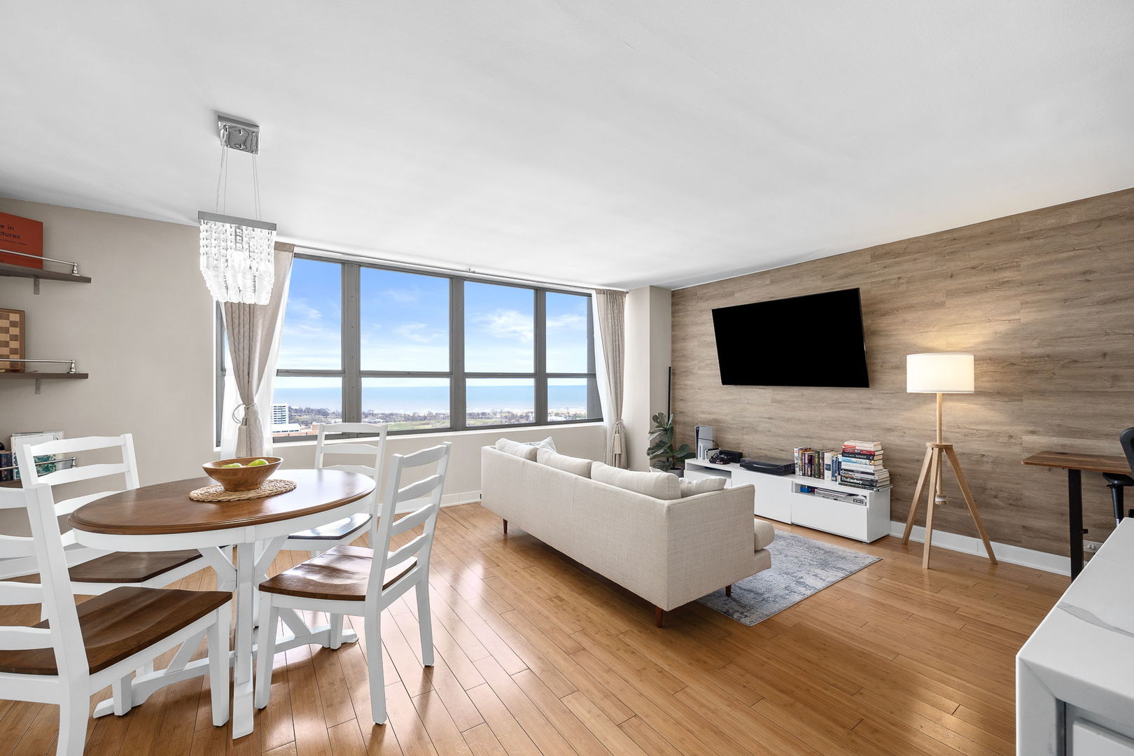 655 West Irving Park Road, Unit 3708 Chicago, IL 60613 - Photo 18 of 55 a living room with furniture flat screen tv and wooden floor