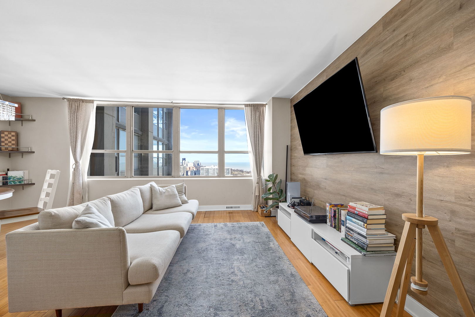 655 West Irving Park Road, Unit 3708 Chicago, IL 60613 - Photo 19 of 55 a living room with furniture and a flat screen tv