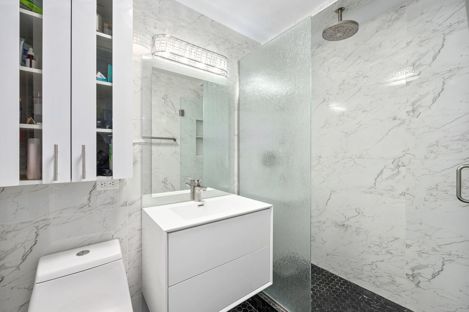 655 West Irving Park Road, Unit 3708 Chicago, IL 60613 - Photo 22 of 55 a bathroom with a sink a toilet and shower